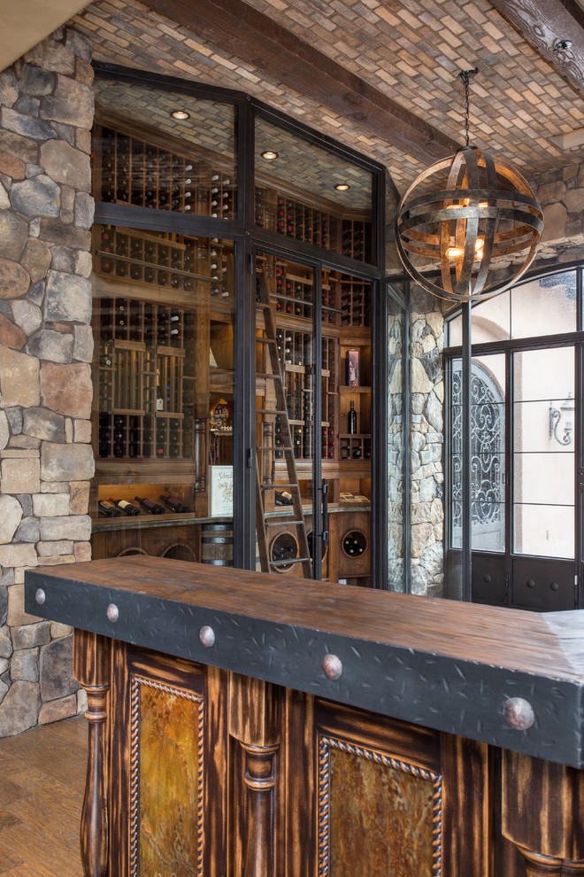 Design ideas for a large traditional wine cellar in Phoenix with brick floors and storage racks.