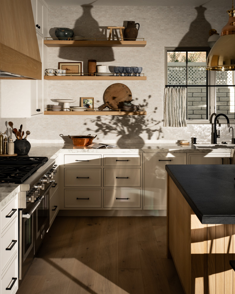 Transitional light wood floor kitchen photo in Orange County with an island