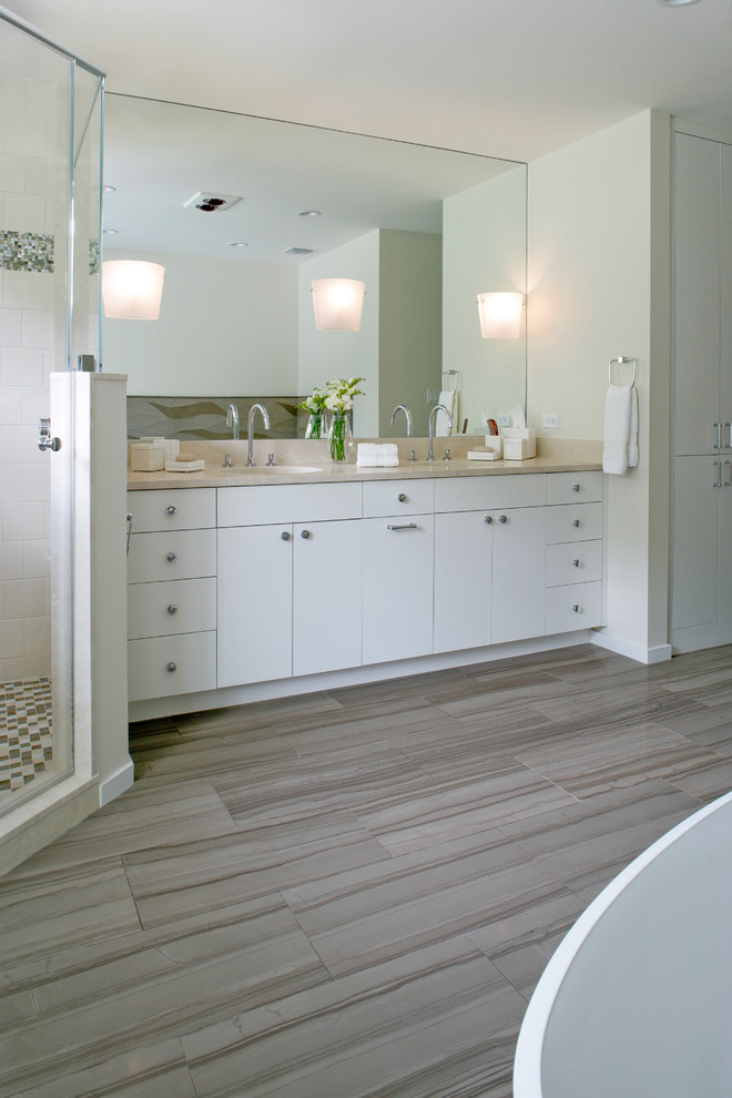 Large transitional master bathroom in Other with flat-panel cabinets, white cabinets, an undermount tub, a corner shower, gray tile, white tile, glass tile, white walls, laminate floors, an undermount sink, marble benchtops, a hinged shower door and brown floor.