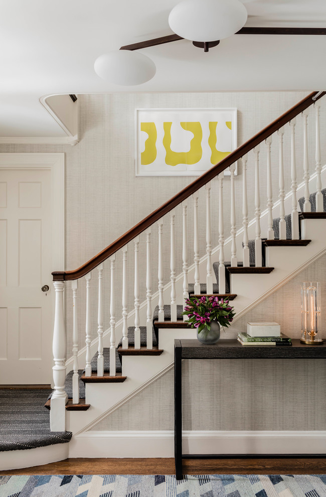 Design ideas for a mid-sized transitional carpeted straight staircase in Boston with carpet risers and wood railing.