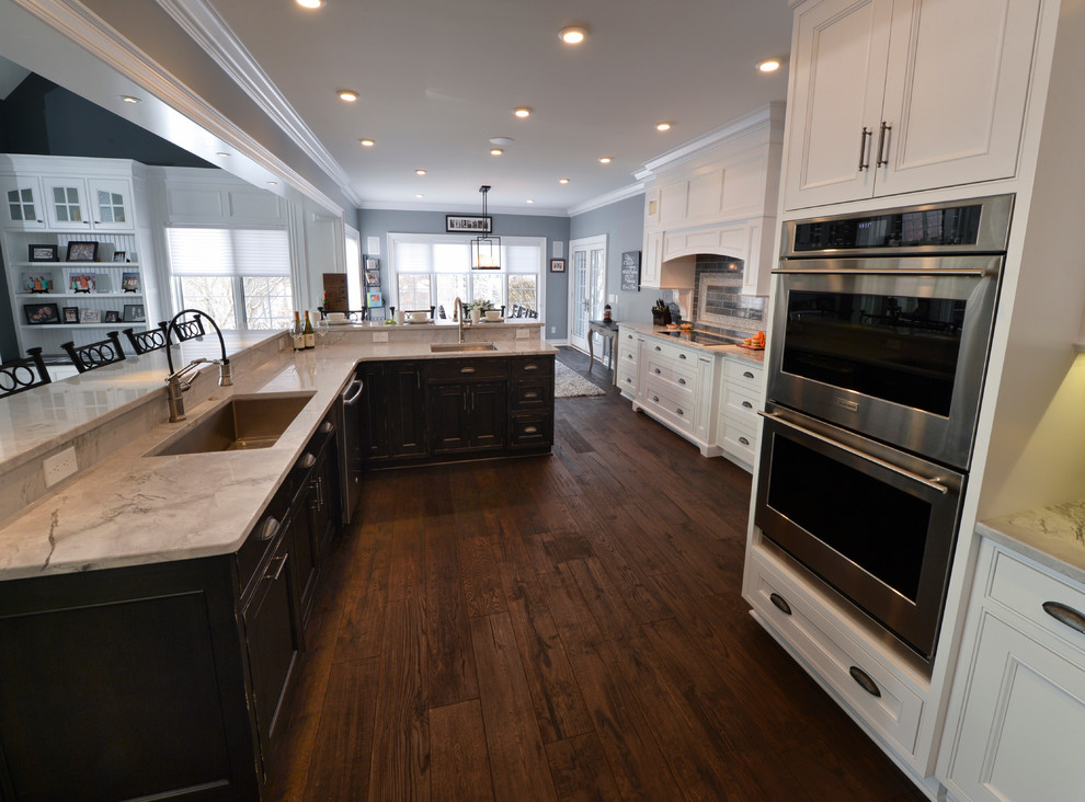 Example of a transitional dark wood floor kitchen design in Cleveland with a single-bowl sink and stainless steel appliances