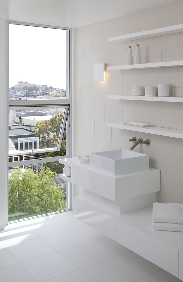 Photo of a modern bathroom in San Francisco with a vessel sink, open cabinets, white cabinets and white tile.