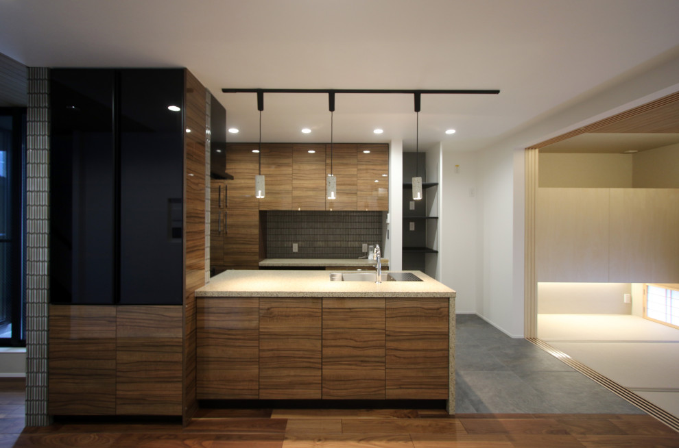 Design ideas for a single-wall open plan kitchen in Kyoto with an undermount sink, beaded inset cabinets, medium wood cabinets, quartz benchtops, grey splashback, mosaic tile splashback, black appliances, ceramic floors, a peninsula, grey floor, beige benchtop and wallpaper.