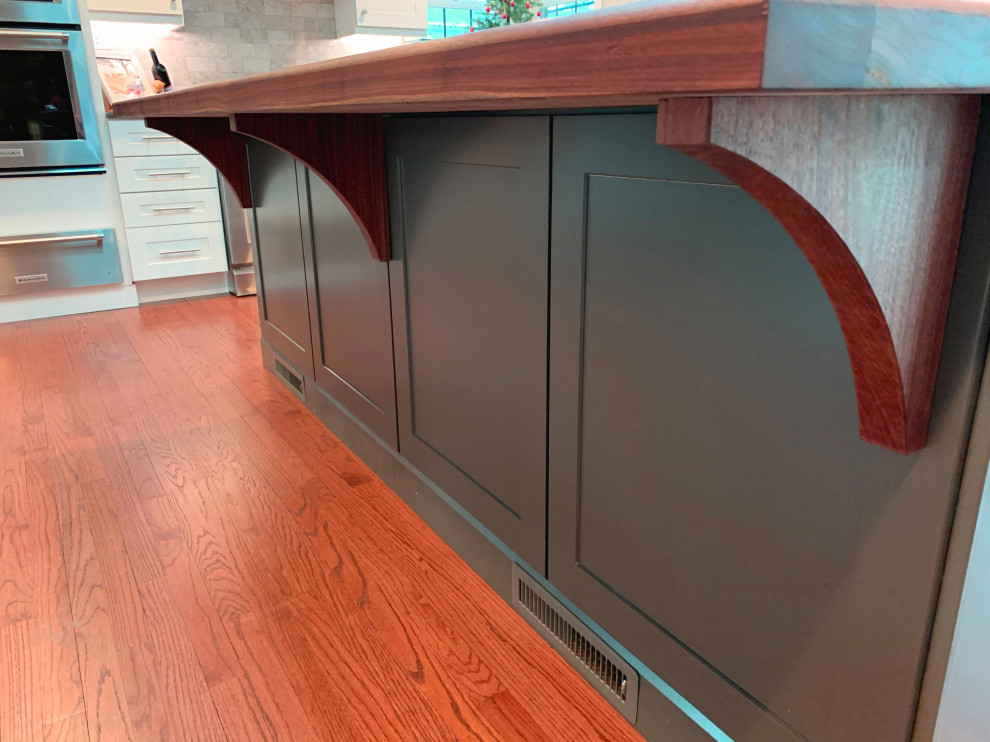 Inspiration for a large contemporary galley medium tone wood floor eat-in kitchen remodel in Chicago with an integrated sink, wood countertops, stainless steel appliances, an island and brown countertops