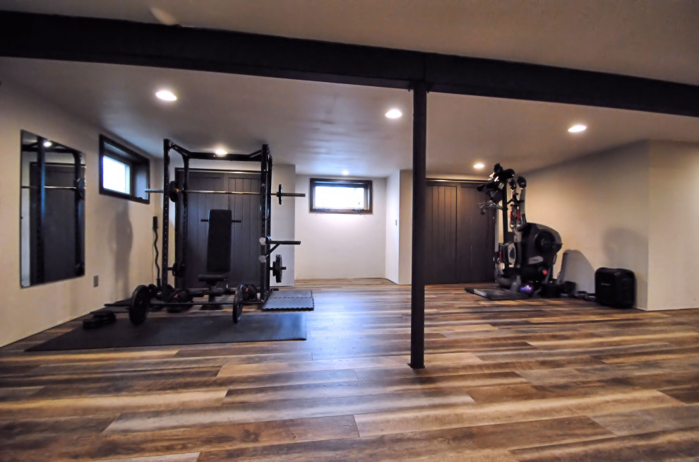 Design ideas for a mid-sized industrial home gym in New York with white walls, vinyl floors and multi-coloured floor.