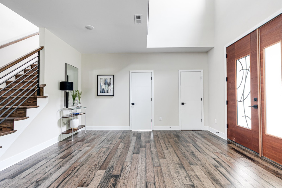 Inspiration for a mid-sized midcentury foyer in Richmond with beige walls, medium hardwood floors, a single front door, a dark wood front door and brown floor.