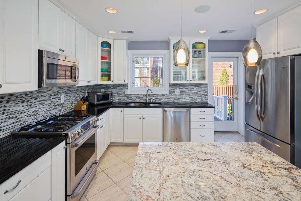Photo of a traditional kitchen in DC Metro with raised-panel cabinets and stainless steel appliances.