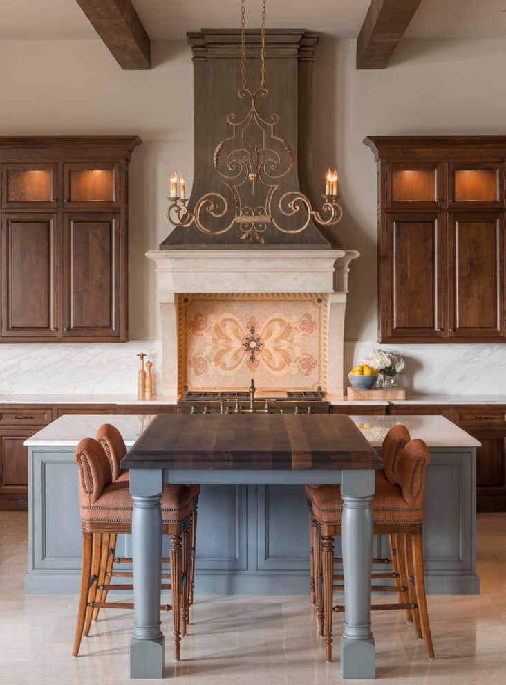 Tuscan beige floor eat-in kitchen photo in Atlanta with raised-panel cabinets, dark wood cabinets, multicolored backsplash and two islands