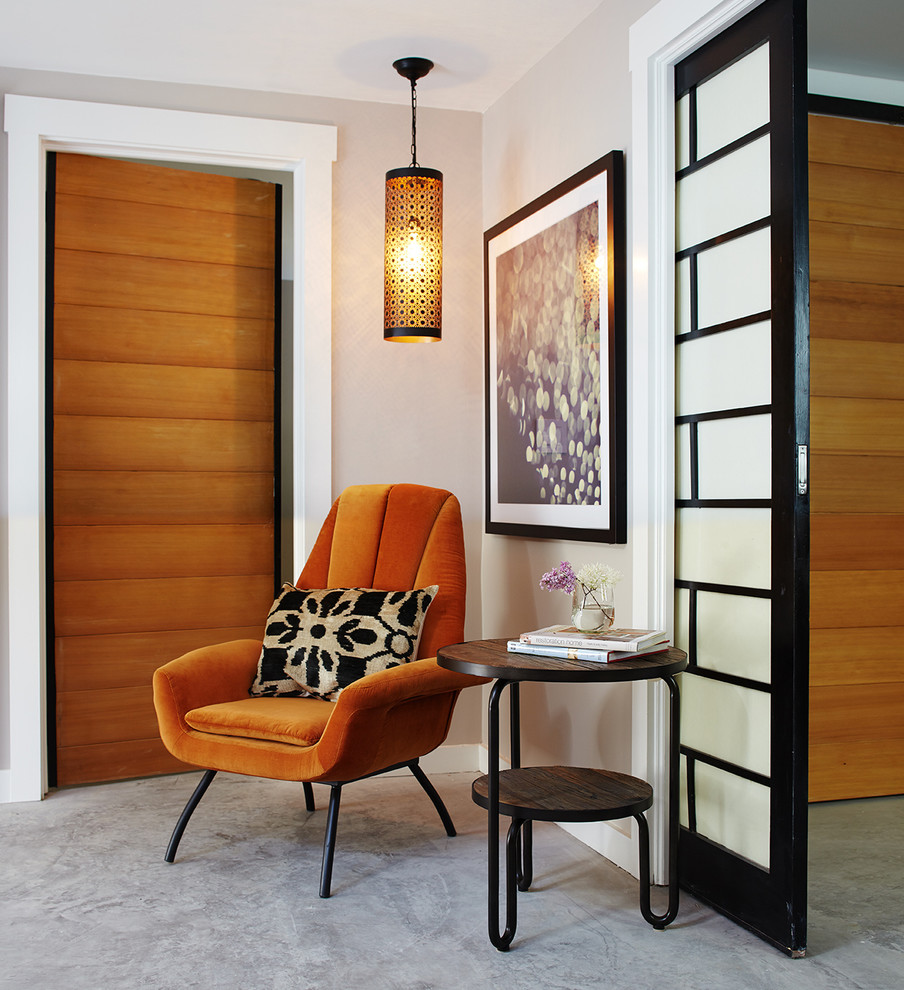 This is an example of a mid-sized modern hallway in San Francisco with beige walls and concrete floors.