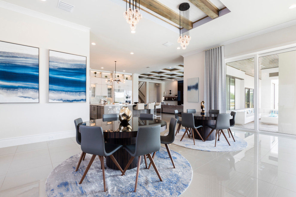 This is an example of an expansive contemporary open plan dining in Orlando with white walls, porcelain floors, a standard fireplace, a wood fireplace surround and beige floor.