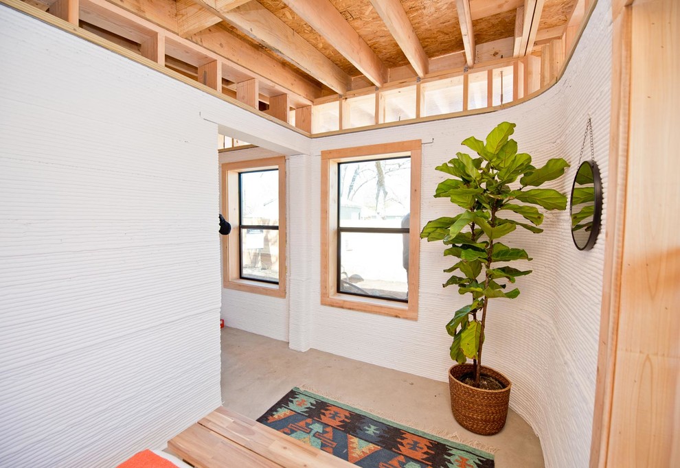 Inspiration for a mid-sized industrial hallway remodel in Austin with white walls