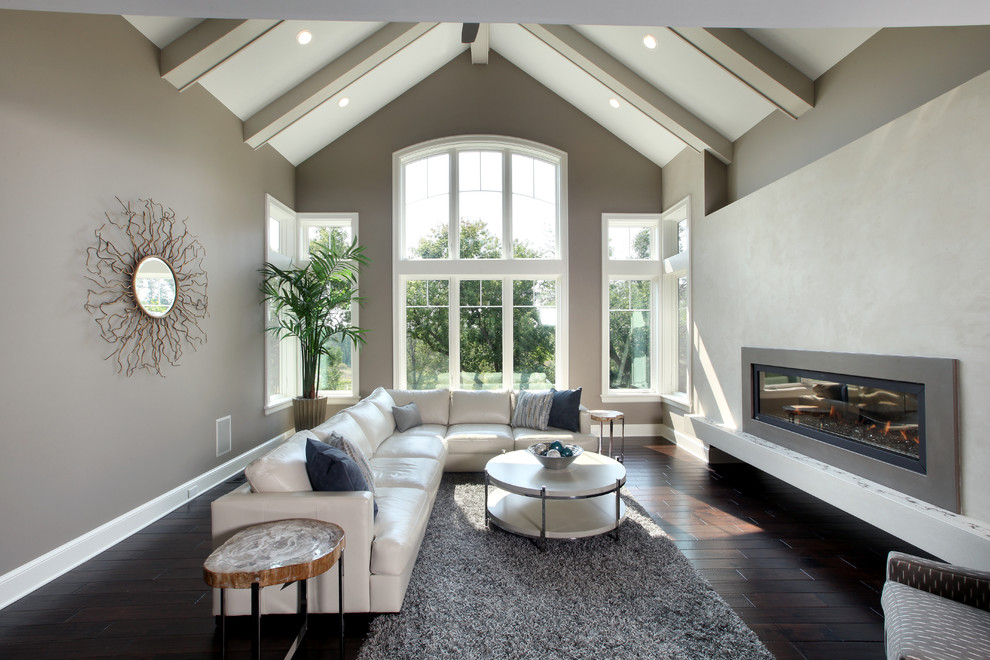 Design ideas for a transitional living room in Grand Rapids with a concrete fireplace surround.