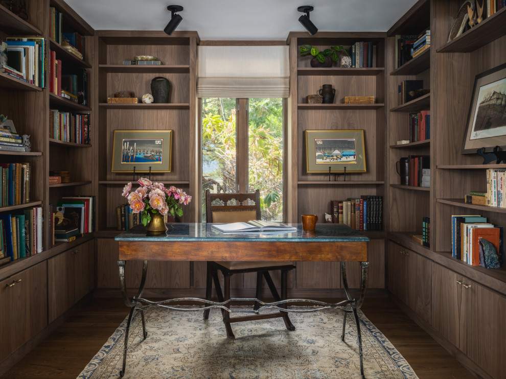 Example of a small mountain style freestanding desk medium tone wood floor and brown floor home office library design in Other with brown walls, a standard fireplace and a stone fireplace