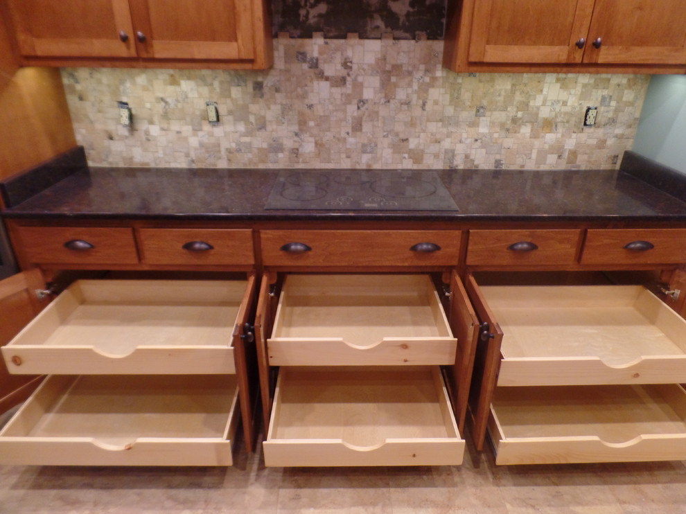 Inspiration for a mid-sized transitional galley home design remodel with an undermount sink, shaker cabinets, medium tone wood cabinets, quartz countertops, multicolored backsplash, travertine backsplash, colored appliances and no island