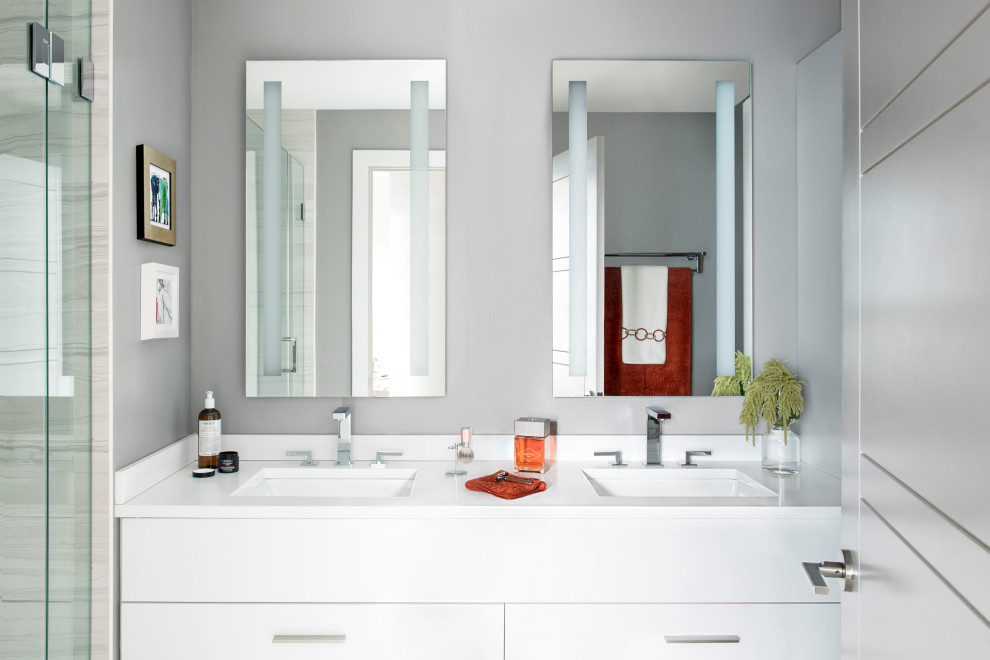 Small modern master bathroom in Boston with flat-panel cabinets, grey cabinets, an open shower, a wall-mount toilet, gray tile, marble, grey walls, porcelain floors, an undermount sink, engineered quartz benchtops, grey floor, a hinged shower door, white benchtops, a double vanity and a floating vanity.