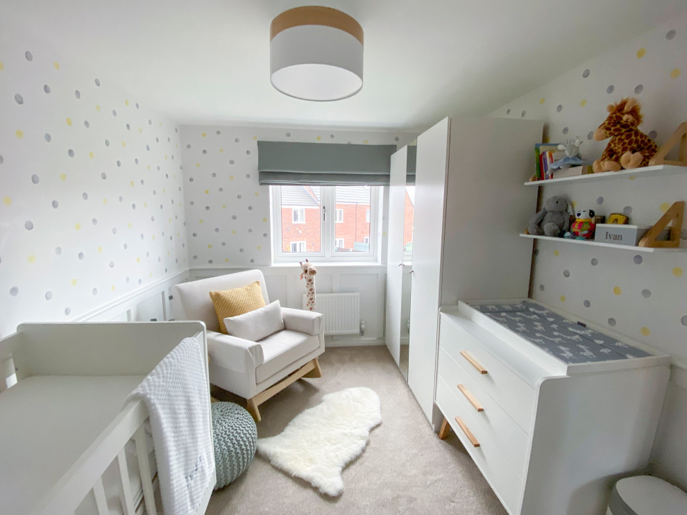 Medium sized modern nursery for boys in Other with white walls, carpet, beige floors and panelled walls.