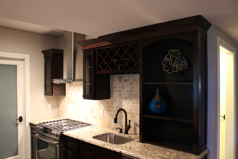 Kitchen - mid-sized transitional galley dark wood floor kitchen idea in Detroit with an undermount sink, recessed-panel cabinets, dark wood cabinets, granite countertops, multicolored backsplash, stone tile backsplash, stainless steel appliances and no island