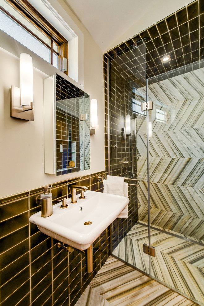 Photo of a small contemporary 3/4 bathroom in New York with a wall-mount sink, a curbless shower, a one-piece toilet, white walls, marble floors, multi-coloured tile, porcelain tile, multi-coloured floor and a hinged shower door.