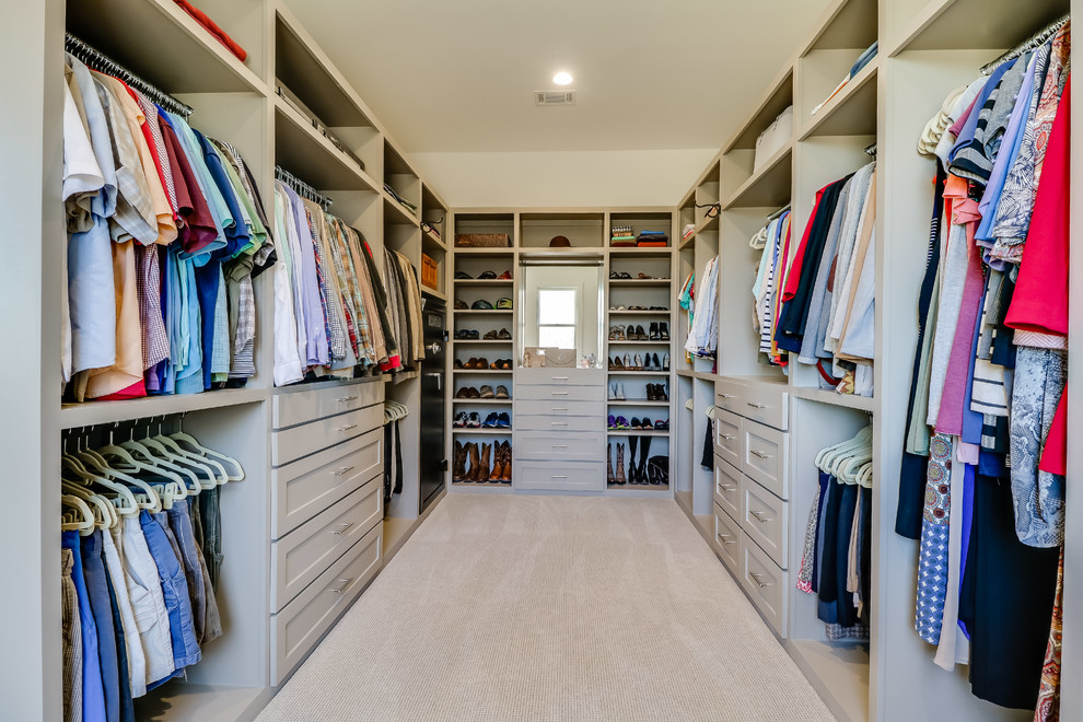 Photo of a large modern gender-neutral walk-in wardrobe in Jackson with shaker cabinets, grey cabinets, carpet and beige floor.