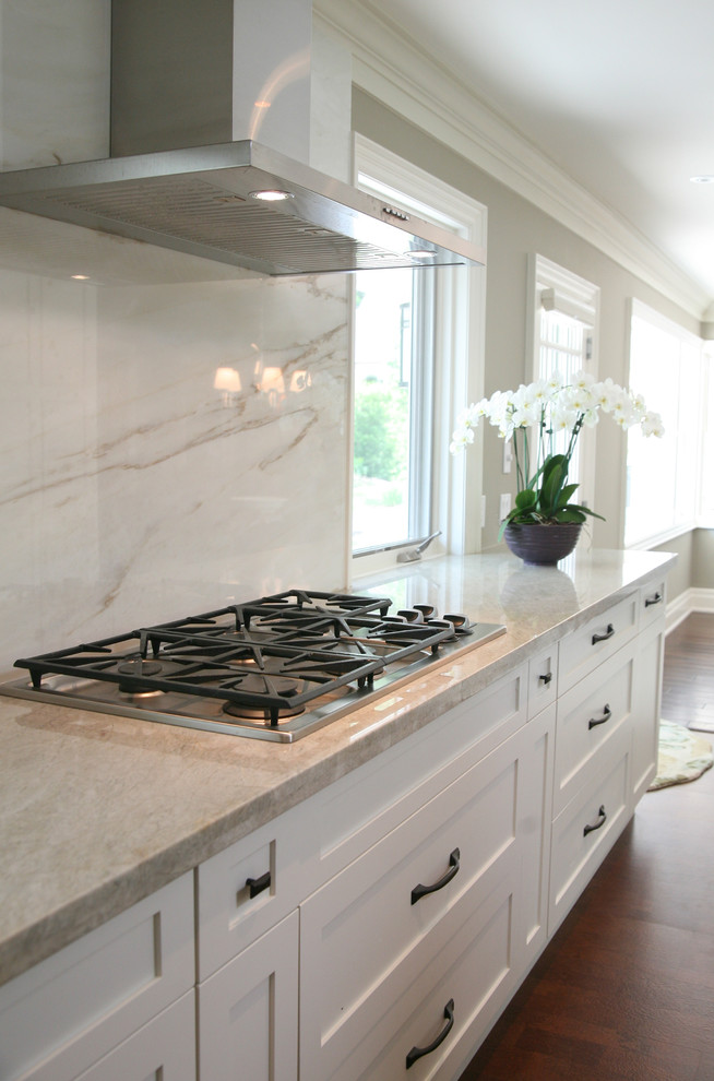 Eat-in kitchen - large transitional l-shaped dark wood floor and brown floor eat-in kitchen idea in Toronto with an undermount sink, shaker cabinets, white cabinets, stainless steel appliances and an island