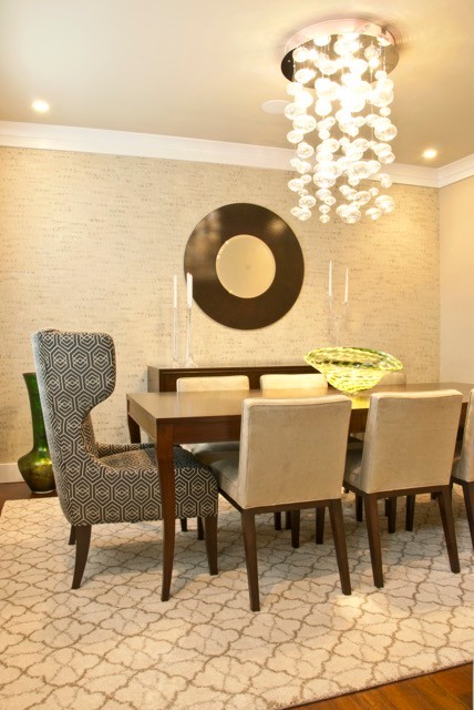 Example of a mid-sized transitional medium tone wood floor enclosed dining room design in DC Metro with gray walls
