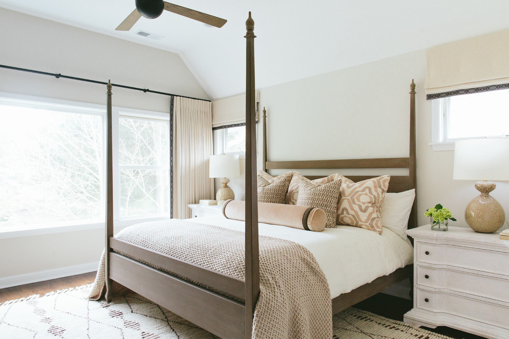 This is an example of a country guest bedroom in Chicago with white walls and dark hardwood floors.