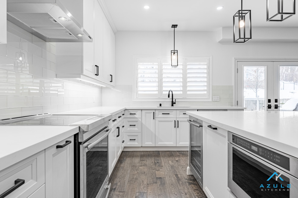 Inspiration for a large transitional u-shaped eat-in kitchen remodel with recessed-panel cabinets, white cabinets, quartz countertops, white backsplash, cement tile backsplash, an island and white countertops