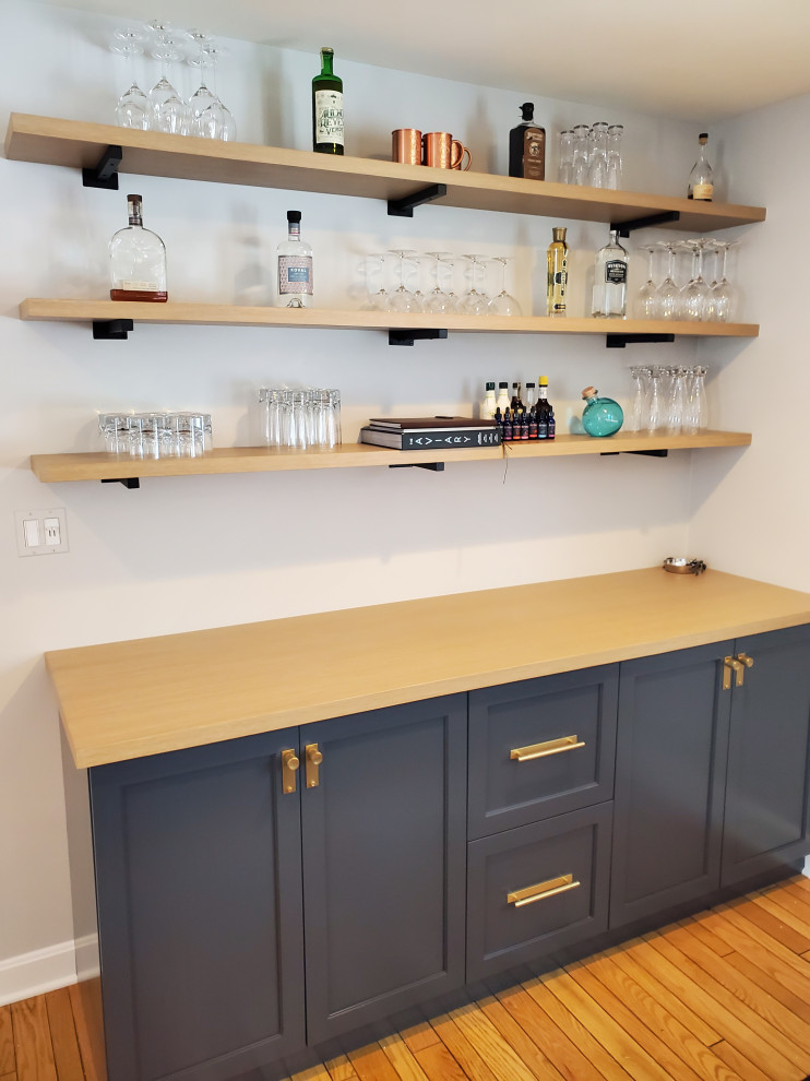 Design ideas for a small classic single-wall dry bar in Chicago with shaker cabinets, blue cabinets, wood worktops and brown worktops.