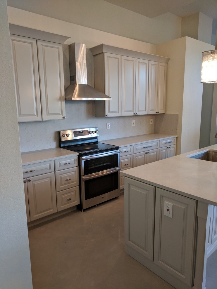 Example of a mid-sized transitional u-shaped porcelain tile and gray floor eat-in kitchen design in Miami with an undermount sink, shaker cabinets, beige cabinets, quartz countertops, white backsplash, stone slab backsplash, stainless steel appliances, an island and white countertops