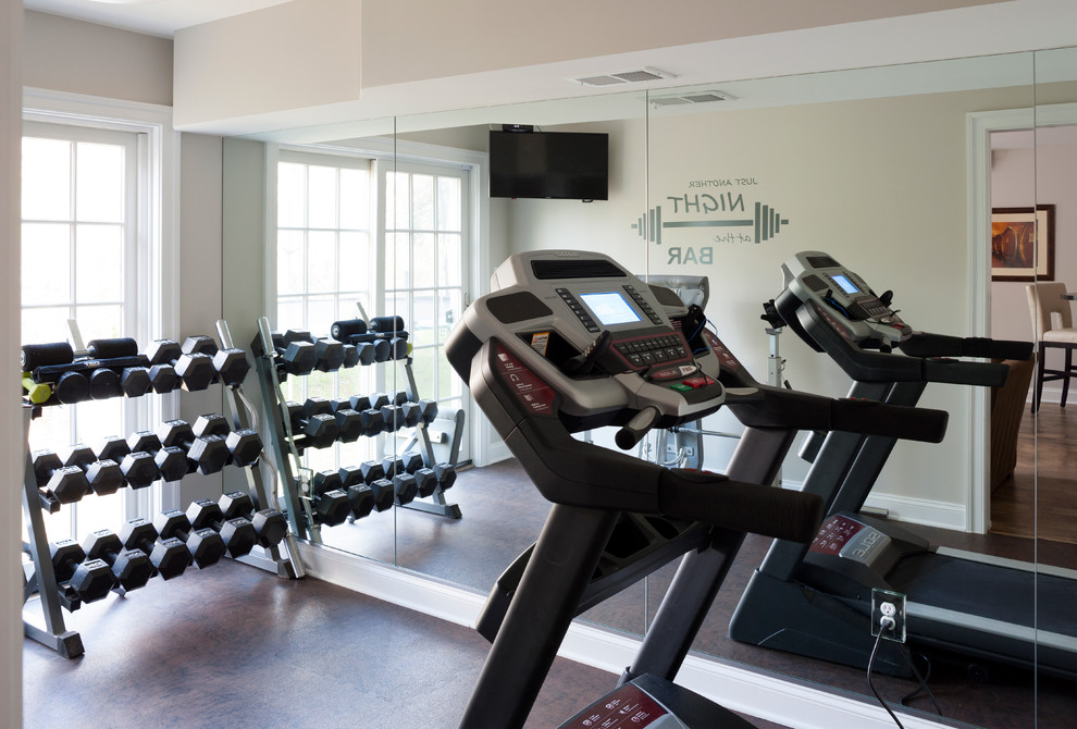 This is an example of a small transitional multipurpose gym in DC Metro with beige walls, brown floor and cork floors.