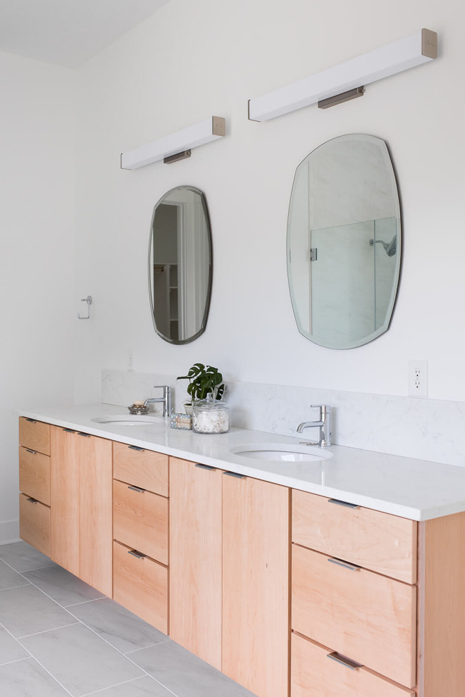 This is an example of a mid-sized scandinavian master bathroom in Indianapolis with flat-panel cabinets, medium wood cabinets, white walls, an undermount sink, engineered quartz benchtops, white benchtops, a double vanity and a built-in vanity.