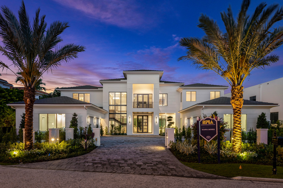 This is an example of a large contemporary two-storey white house exterior in Miami.