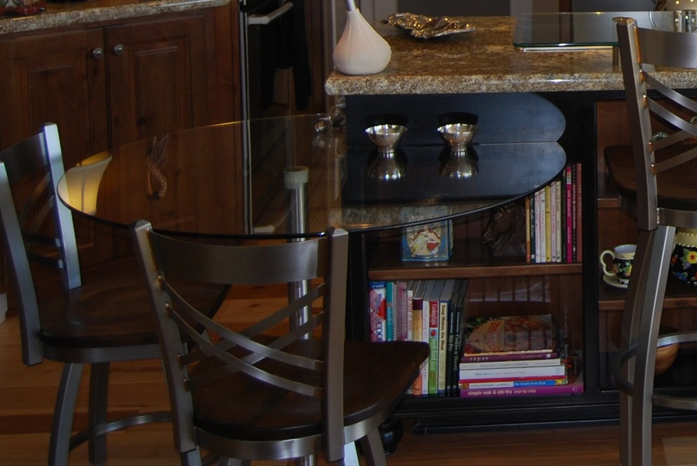 Mid-sized transitional u-shaped medium tone wood floor open concept kitchen photo with an undermount sink, raised-panel cabinets, medium tone wood cabinets, granite countertops, beige backsplash, stone tile backsplash, stainless steel appliances, beige walls and an island