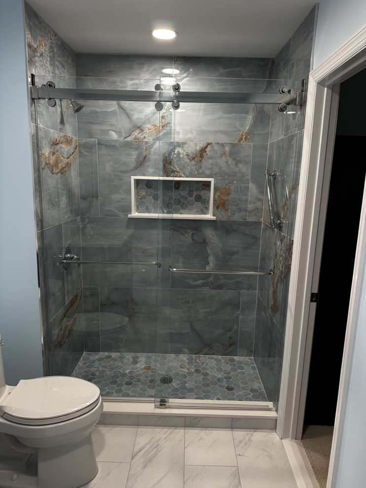Design ideas for a mid-sized master bathroom in New York with blue cabinets, an alcove shower, blue tile, blue walls, an undermount sink, engineered quartz benchtops, white floor, a sliding shower screen, white benchtops, a niche, a single vanity and a freestanding vanity.