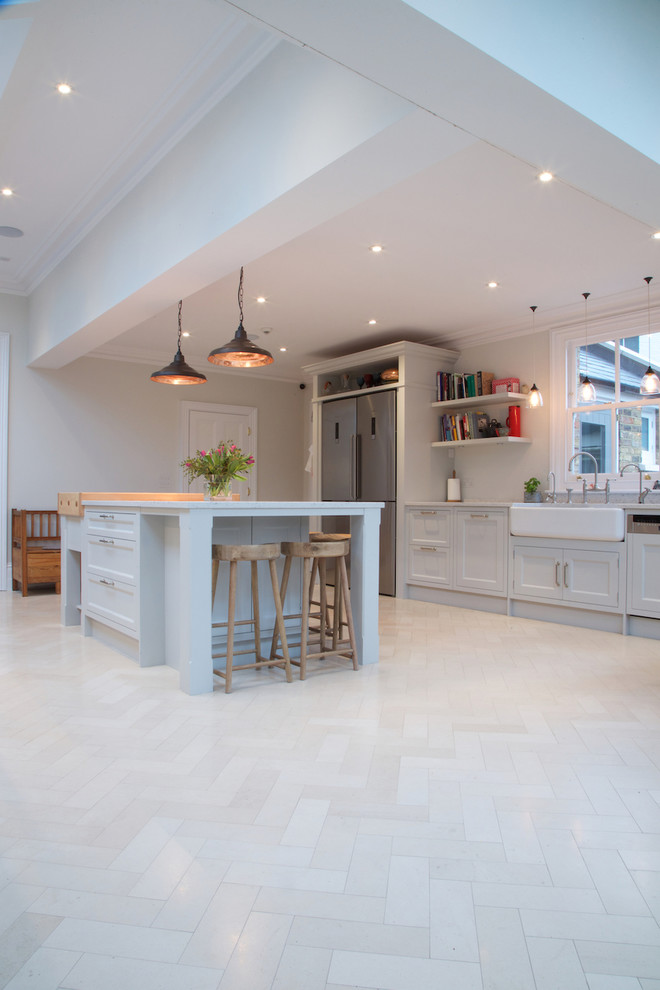 Modern kitchen in London with limestone floors.