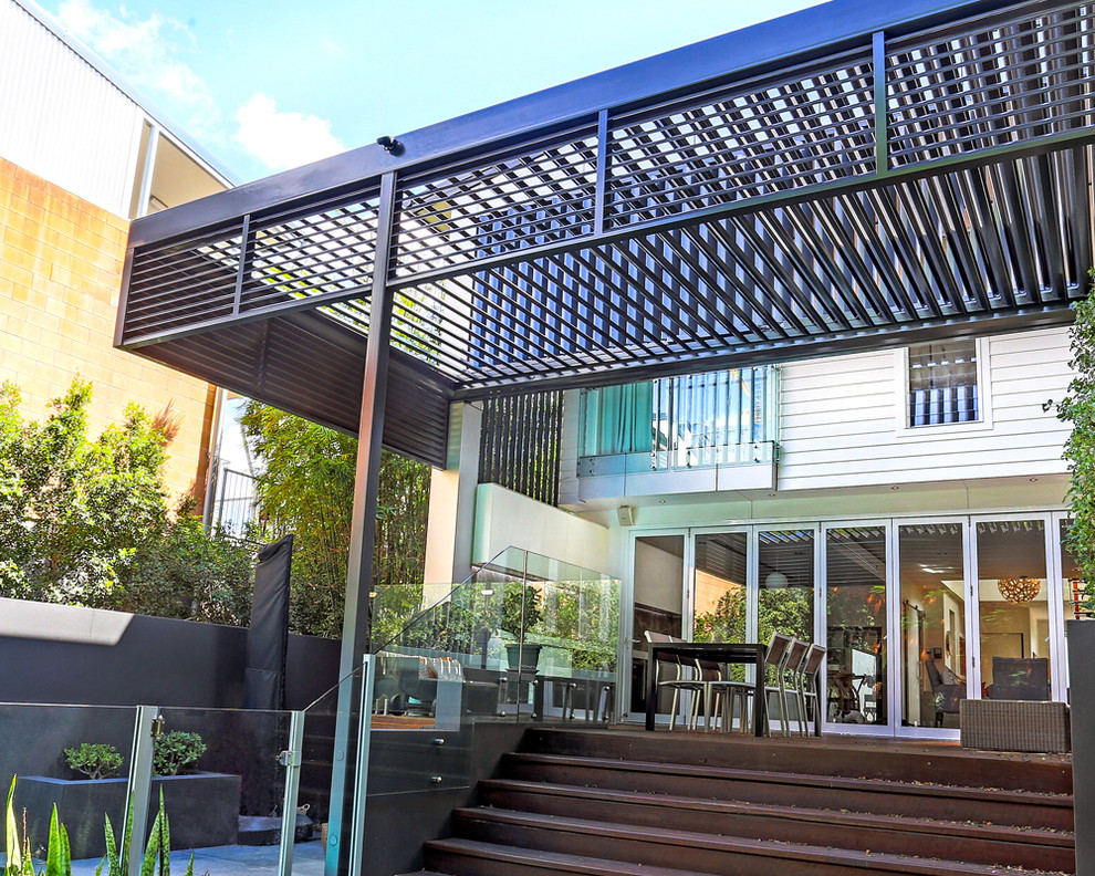 Example of a mid-sized trendy home design design in Brisbane