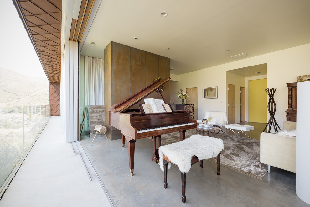 This is an example of a contemporary open concept living room in Salt Lake City with white walls and concrete floors.