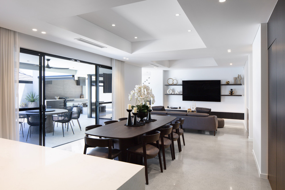 Design ideas for a large modern open plan dining in Perth with white walls, concrete floors, no fireplace, a concrete fireplace surround, grey floor, recessed and wood walls.
