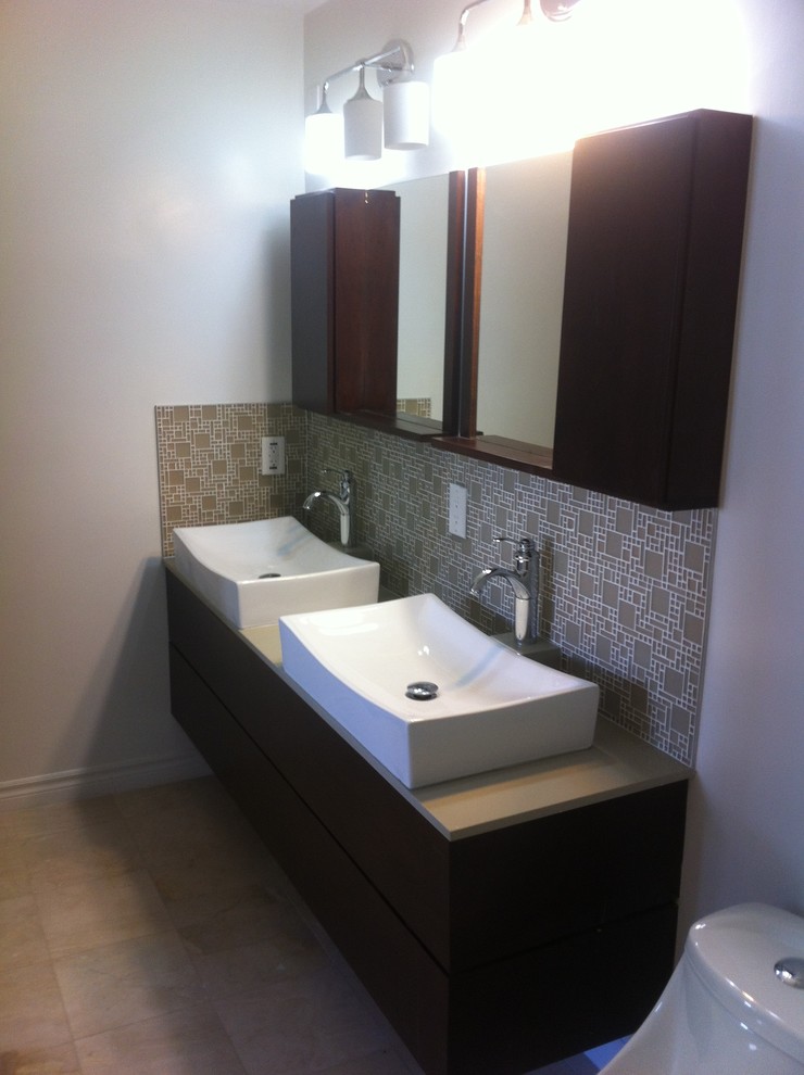 Photo of a mid-sized modern master bathroom in Los Angeles with flat-panel cabinets, dark wood cabinets, brown tile, gray tile, glass tile, grey walls, light hardwood floors and a vessel sink.
