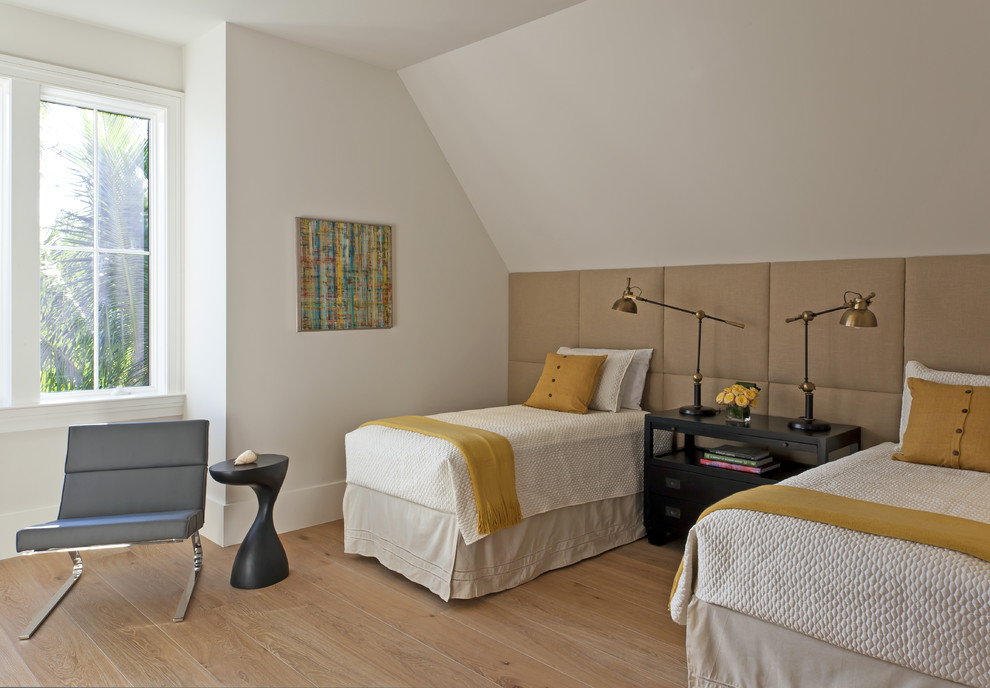 This is an example of a mid-sized transitional guest bedroom in Miami with white walls and light hardwood floors.