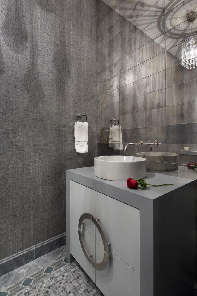 Design ideas for a small contemporary powder room in San Francisco with flat-panel cabinets, white cabinets, multi-coloured tile, mirror tile, grey walls, mosaic tile floors, a vessel sink, solid surface benchtops and grey floor.