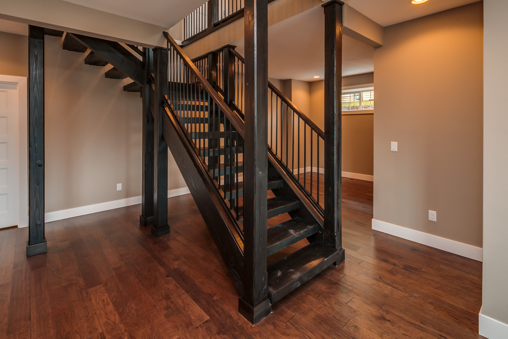 Large transitional wood l-shaped staircase in Seattle with open risers.