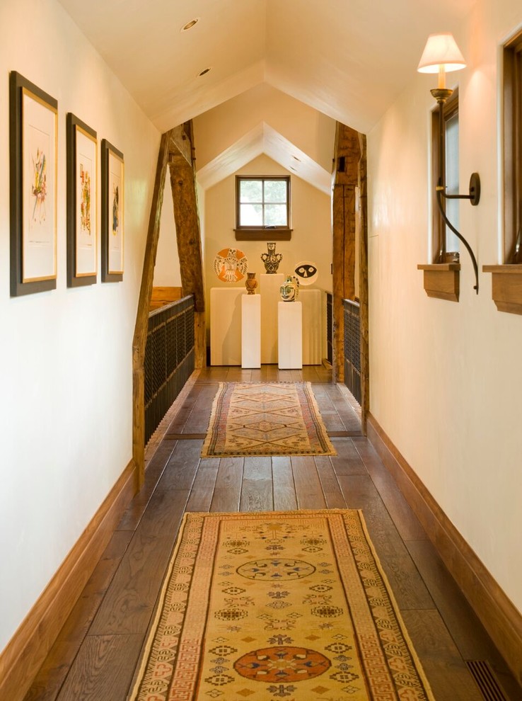 Hallway - mid-sized rustic medium tone wood floor and brown floor hallway idea in Denver with white walls