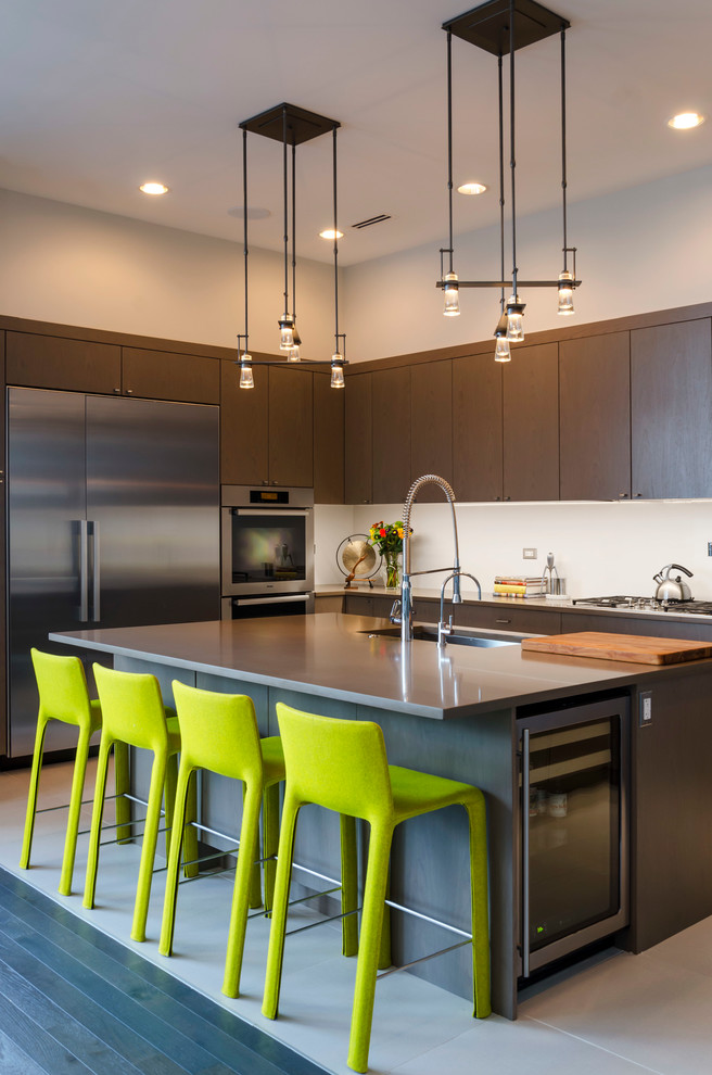 Kitchen - transitional kitchen idea in Chicago with an undermount sink, flat-panel cabinets, dark wood cabinets, white backsplash, stainless steel appliances and an island
