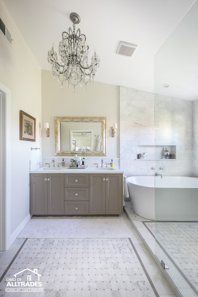 Mid-sized transitional master wet room bathroom in San Diego with flat-panel cabinets, grey cabinets, a freestanding tub, gray tile, marble, white walls, marble floors, an integrated sink, marble benchtops, multi-coloured floor, an open shower and white benchtops.