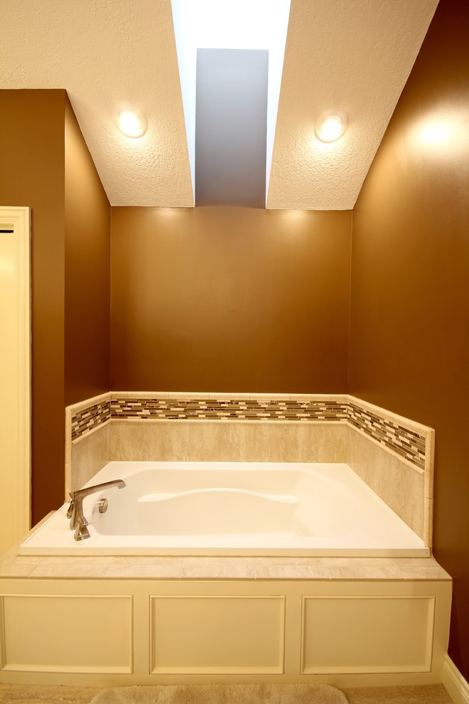 Photo of a mid-sized contemporary master bathroom in Other with a drop-in tub, an alcove shower, ceramic tile, ceramic floors, quartzite benchtops, raised-panel cabinets, white cabinets, beige tile, brown walls and an undermount sink.