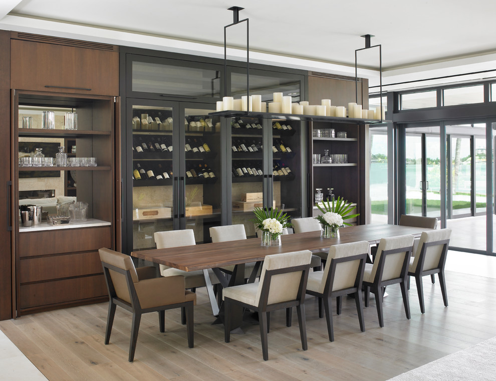 Contemporary dining room in Miami with light hardwood floors and beige floor.