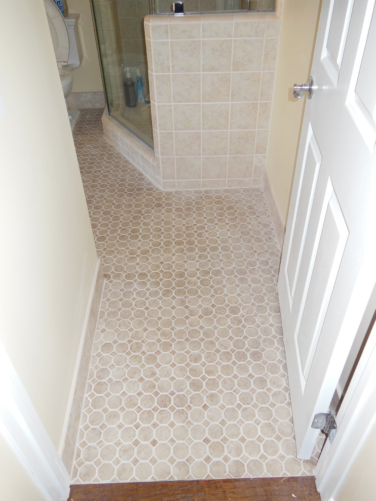 Design ideas for a small traditional bathroom in Orange County with a corner shower, beige tile and ceramic floors.