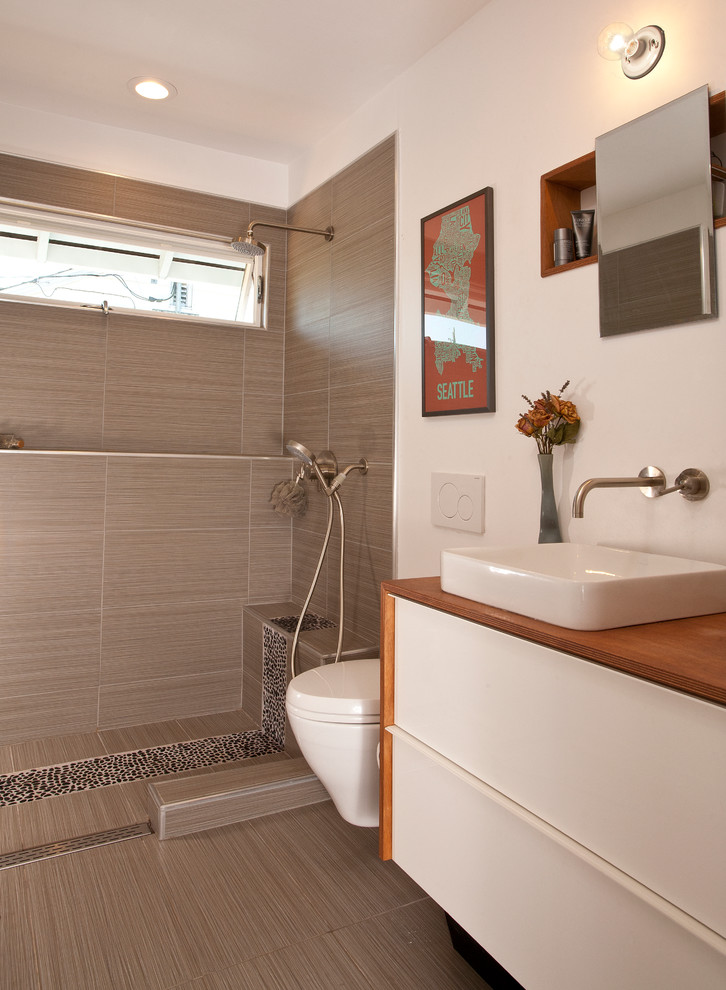 Photo of a contemporary 3/4 bathroom in Seattle with a vessel sink, flat-panel cabinets, white cabinets, an open shower, beige tile, white walls and an open shower.