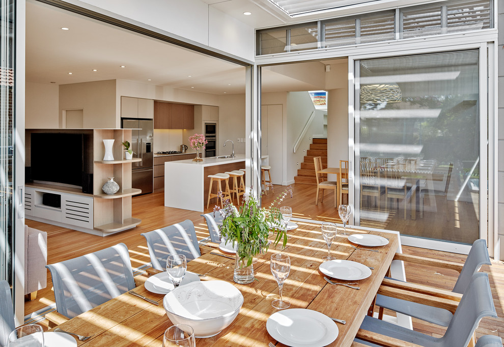 Photo of a mid-sized contemporary backyard deck in Sydney with a pergola.